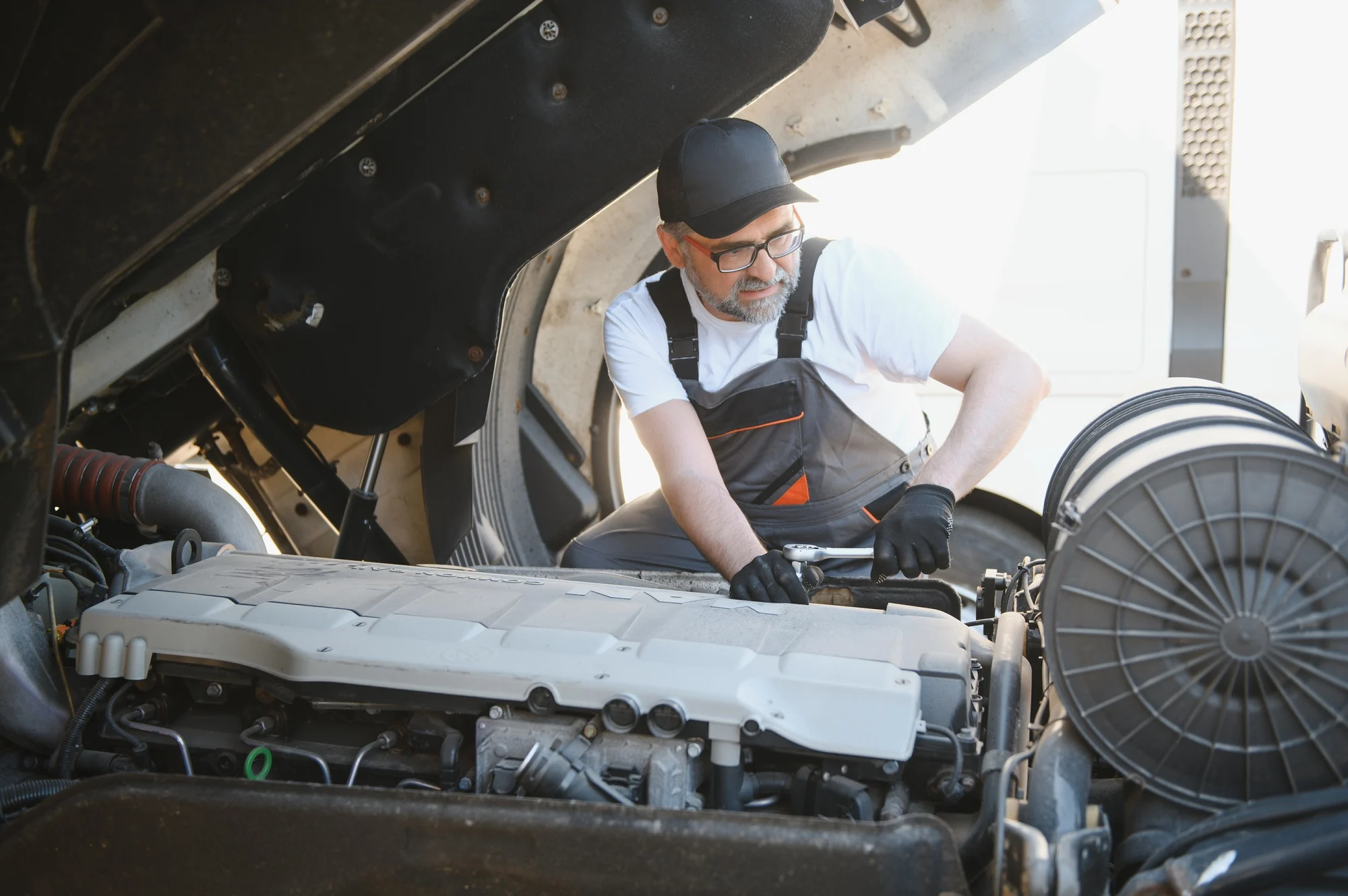 Professional truck mechanic working in vehicle repair service